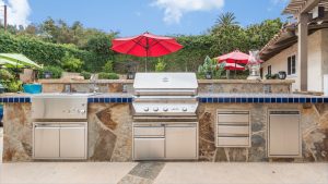 Custom BBQ Island. Tile - NPT Iberia La Mancha. Stone Veneer - O2 Stack Stone Veneer.