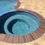 spa with crystal blue radiance brick coping brown flash and orco vill pavers