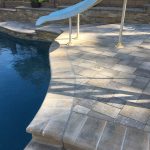 Pool with slide and raised bond beam