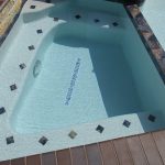 Spa with trim tile and spill way
