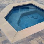 Spa with drains and pebble finish